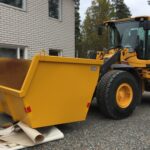 Hjullastare med Stora BM-Container